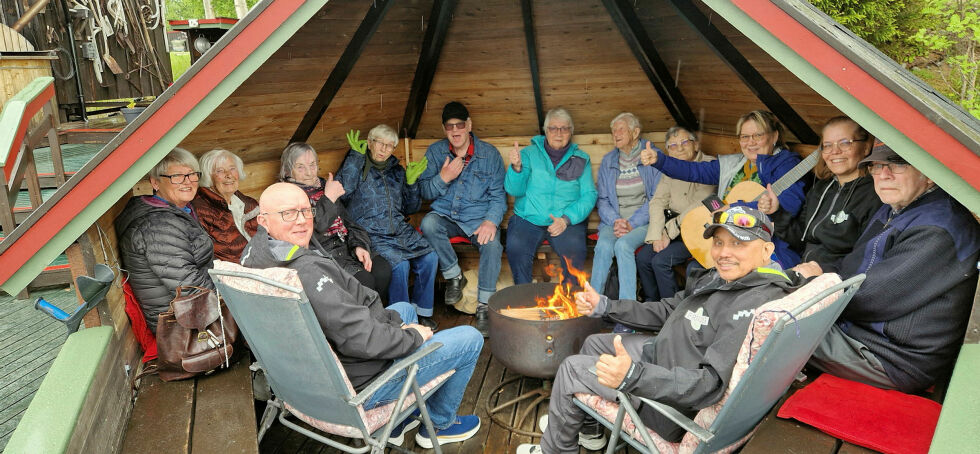 På brygga står det en gapahuk, der gruppa spilte og sang til regnet holdt opp. Foran sitter de to frivillige, Tor Inge Ringfoss og Joseph Bantolo, og bak fra venstre: Kari Pettersen, Kari Jakobsen, Ann-May Emanuelsen, Svea Andersen, Thormod Hoel, Torid Gjetmundsen, Eva Øien Guvåg, Helga Johnsen, Unni Eliassen, Marita Berggren og Svein Nilsen.
 Foto: Hill Haga